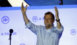 Spain's acting prime minister and People's Party (PP) leader Mariano Rajoy waves to supporters at party headquarters after Spain's general election in Madrid